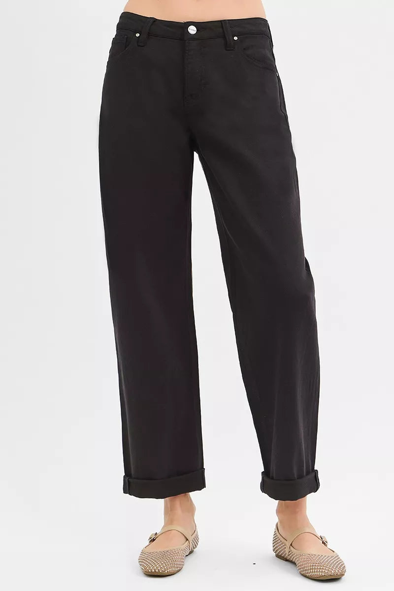 Black pants worn by a person on a white background