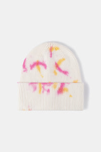 White beanie with colorful designs on a white background