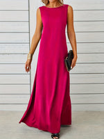 Woman wearing a bright pink sleeveless dress against a light wooden panel background