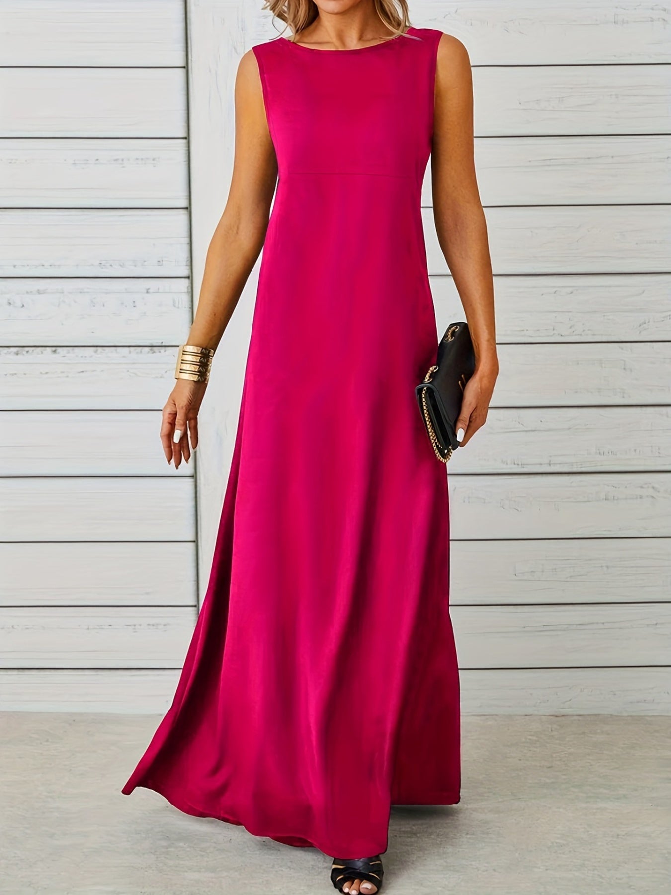 Woman wearing a bright pink sleeveless dress against a light wooden panel background