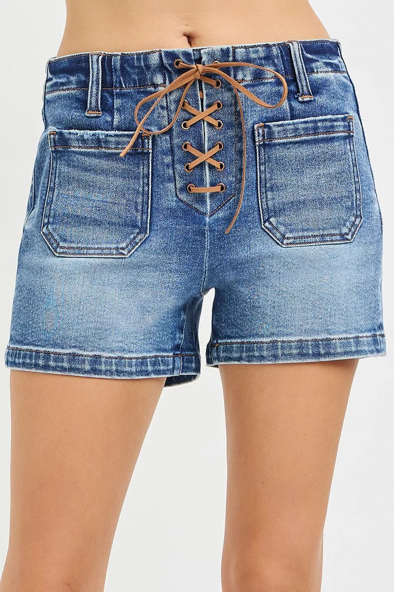 Blue denim shorts with lace-up front on a white background