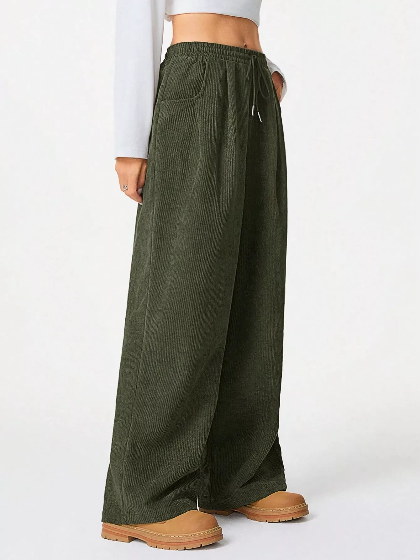 Green wide-leg pants worn by a person on a white background