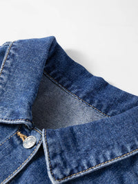 Close-up of a blue denim jacket collar on a light gray background