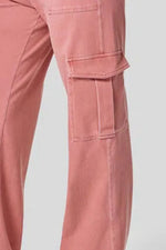 Close-up of pink cargo pants on a light gray background