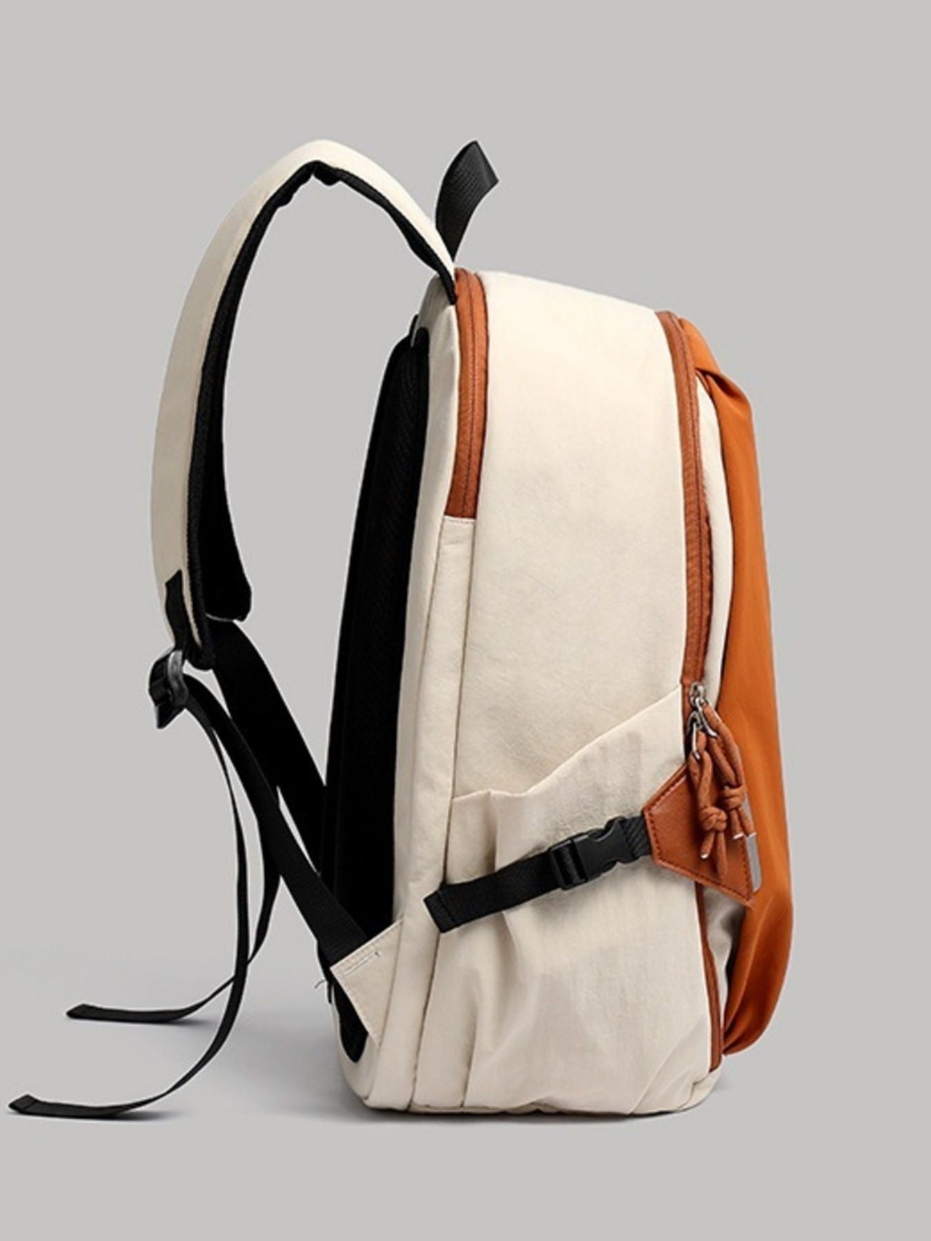 Beige and brown backpack on a gray background