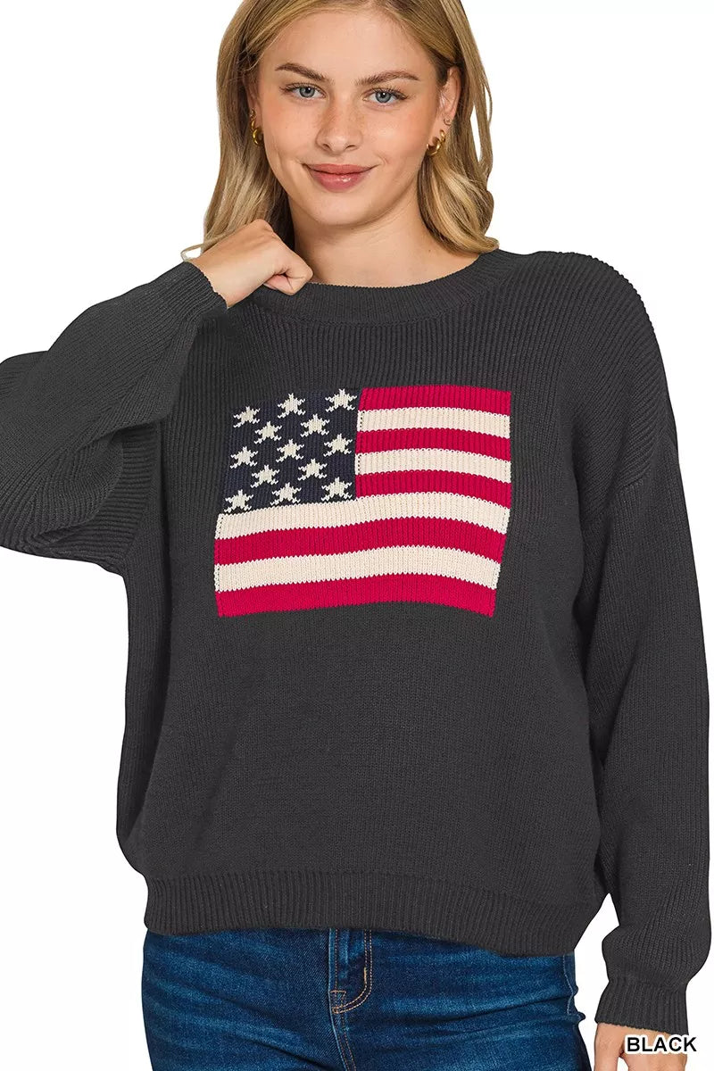 Woman wearing a black sweater with an American flag design on a white background