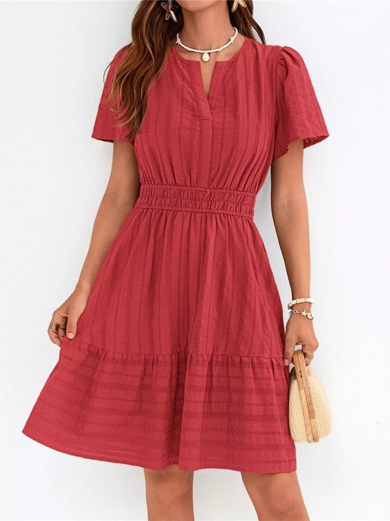 Red dress worn by a person on a white background