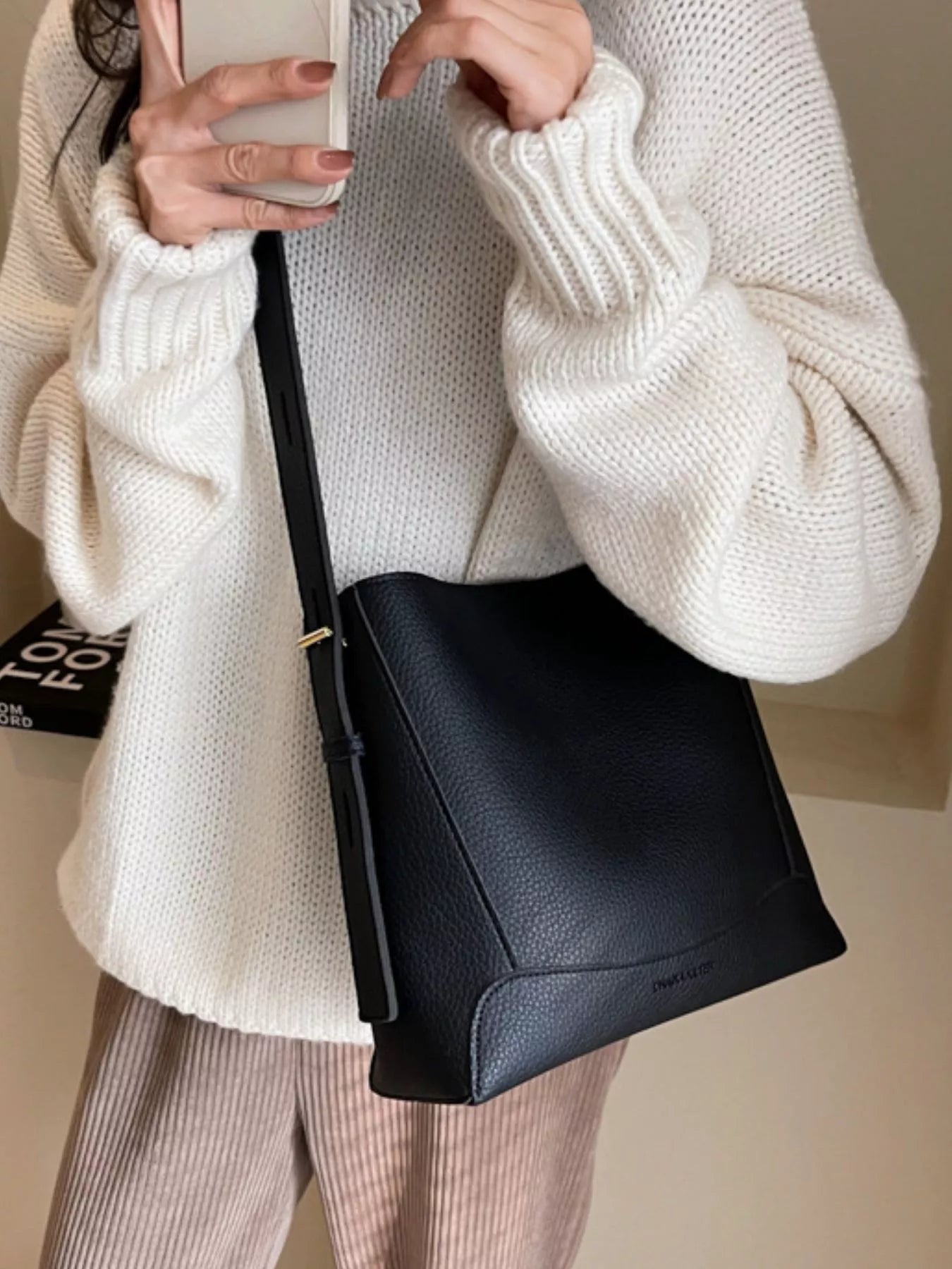 Lady is carrying Women's Leather Adjustable Strap Crossbody Bag