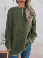 Green sweater worn by a person with a white brick wall background