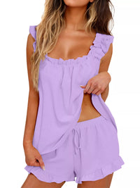 Woman wearing a light purple romper with ruffled straps on a white background