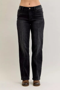 Black jeans worn by a person on a plain background