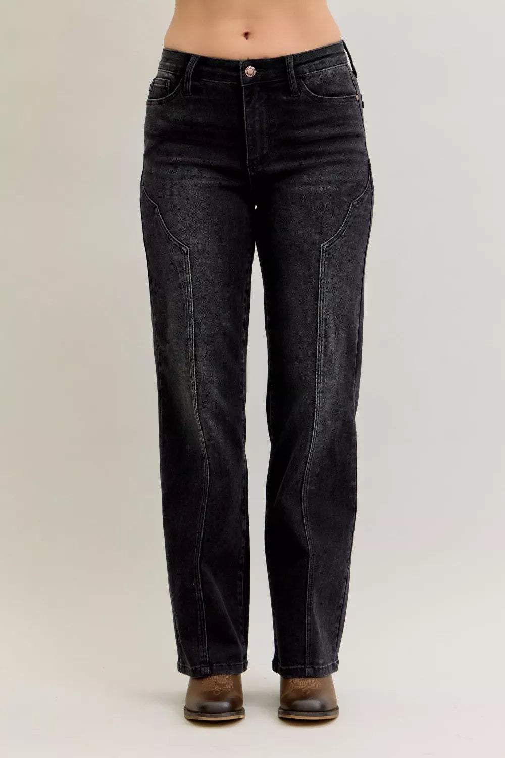 Black jeans worn by a person on a plain background