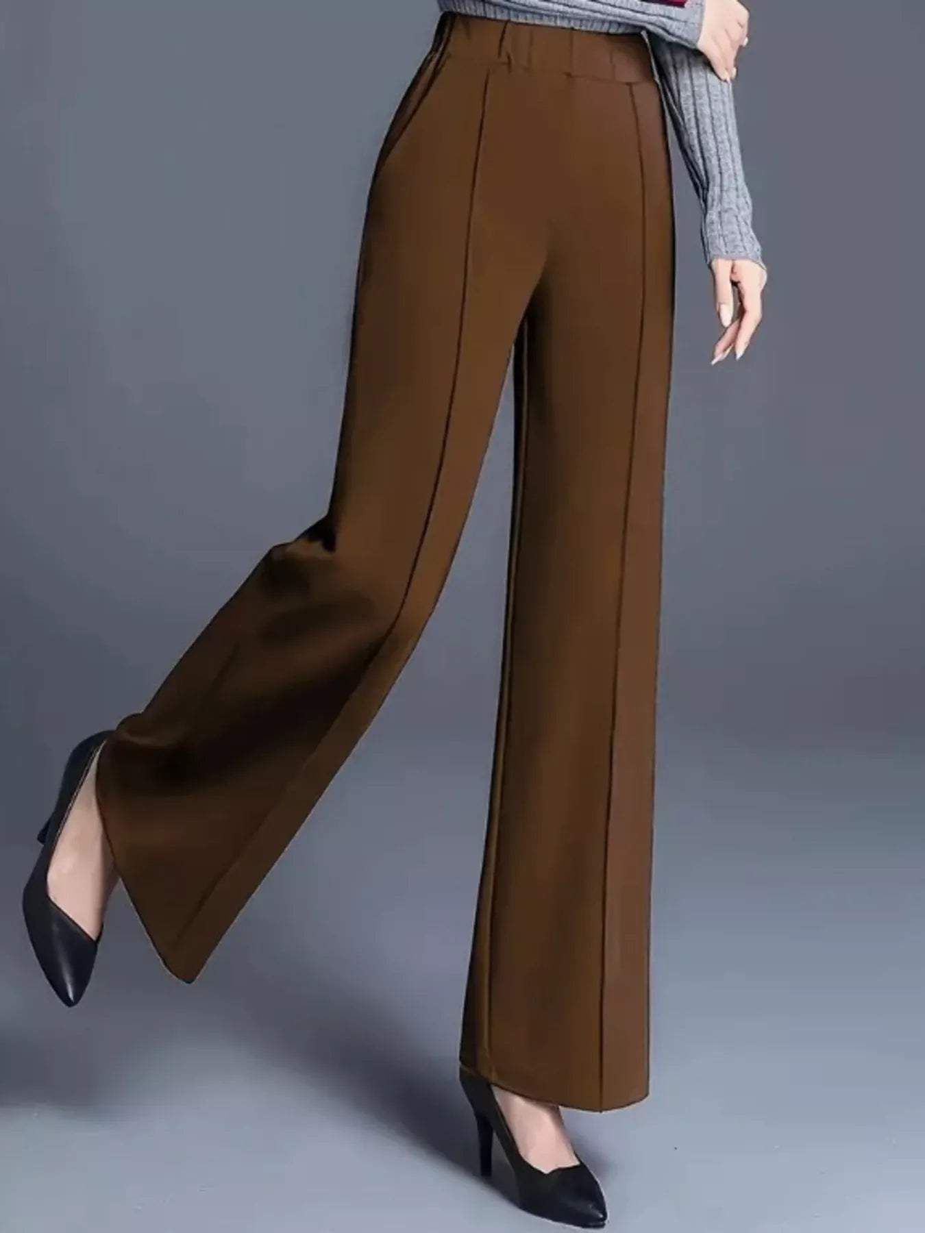 Brown wide-leg pants worn by a person on a gray background