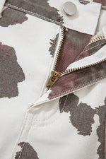 Close-up of a zipper on a camouflage-patterned jacket