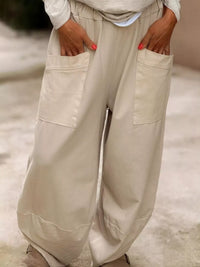 Beige wide-leg pants worn by a person with a blurred background