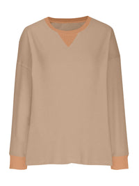 Beige long-sleeve shirt with a subtle pattern on a white background