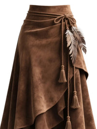 Brown suede skirt with feather and tassel details on a white background