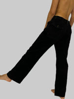 Black pants worn by a person on a plain background