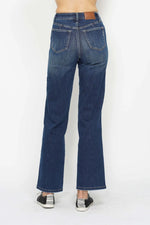Blue jeans worn by a person on a white background