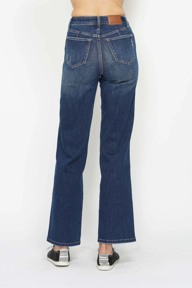 Blue jeans worn by a person on a white background