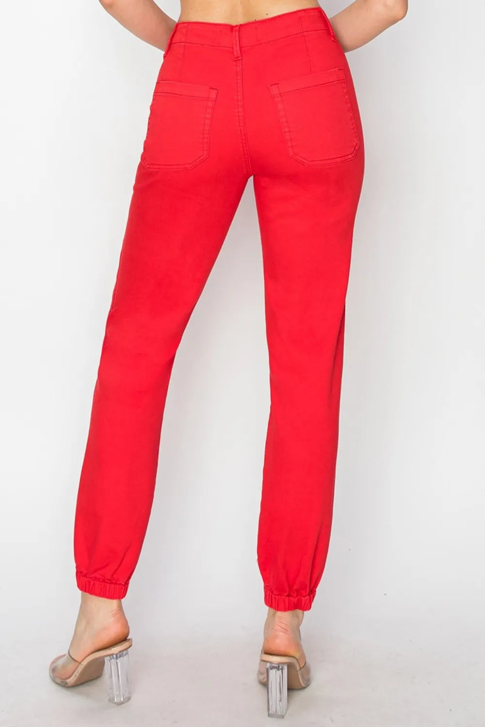 Red pants worn by a person on a white background