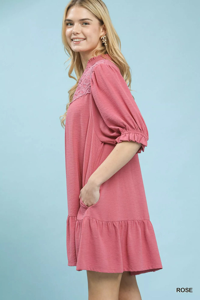 Woman wearing a pink dress against a light blue background