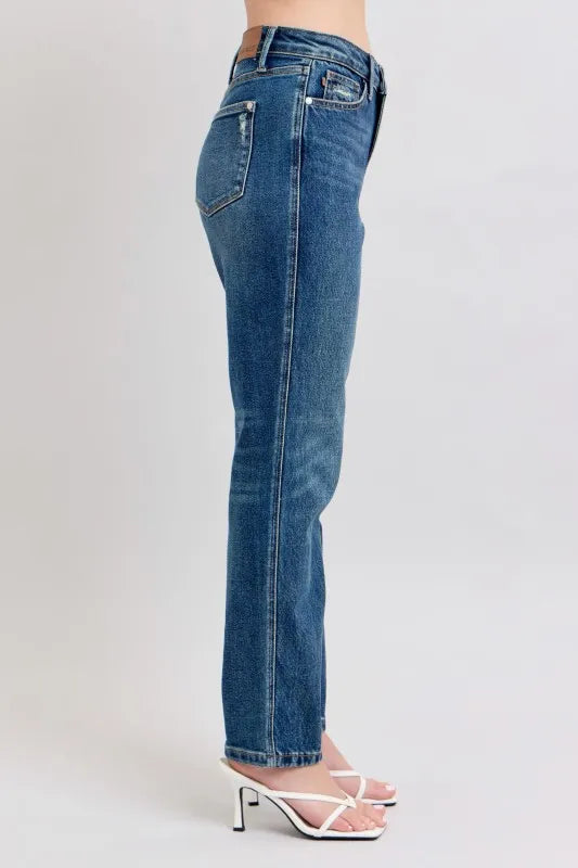 Blue jeans worn by a person on a light gray background