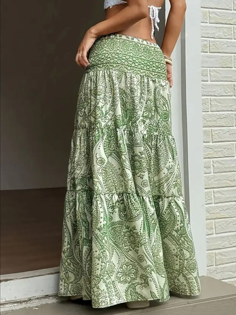 Green patterned skirt worn by a person against a neutral background