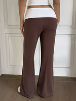 Brown flared pants worn by a person against a neutral background