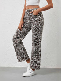 Person wearing leopard print pants with a white background