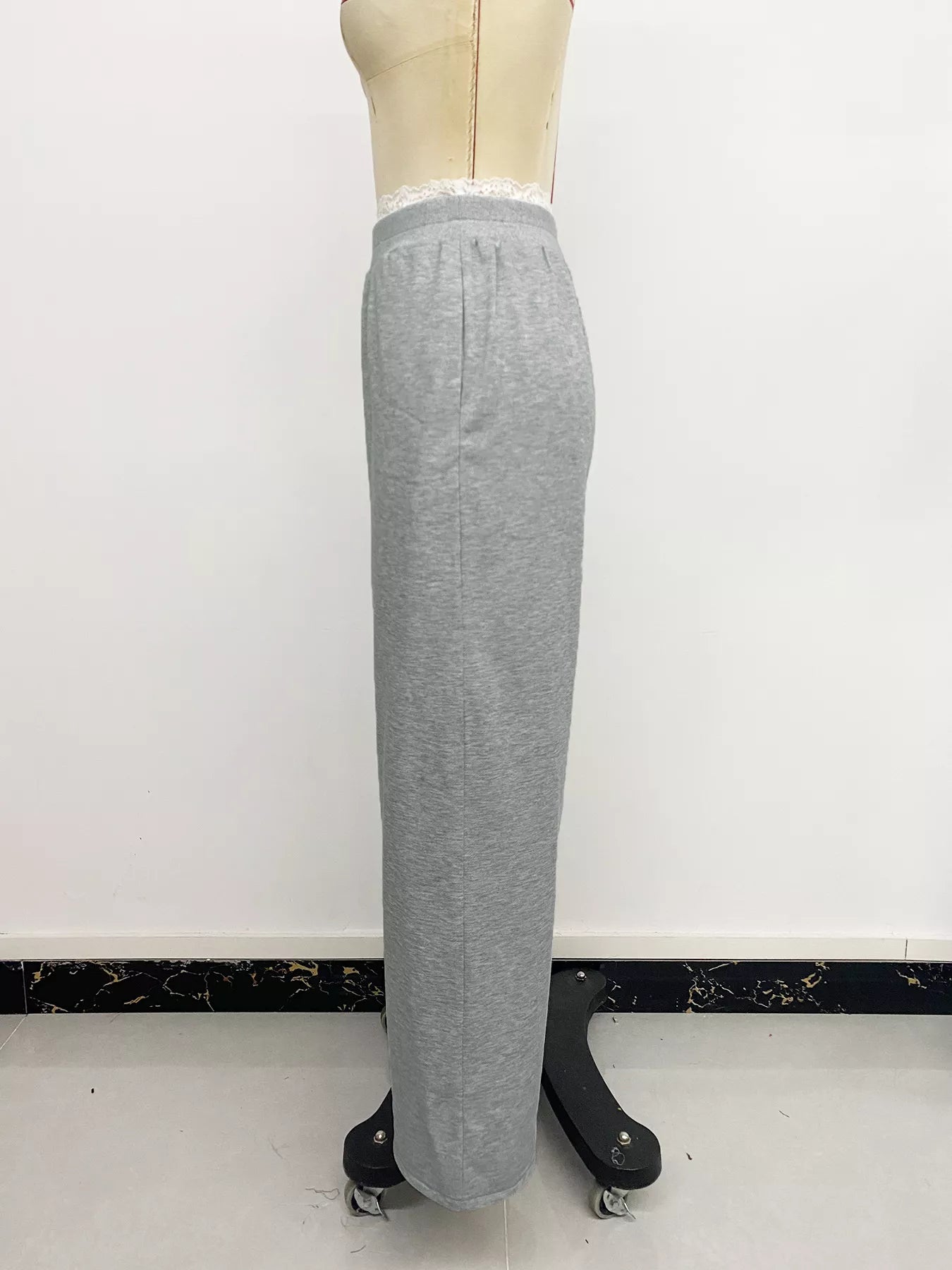 Gray sweatpants on a mannequin against a white background