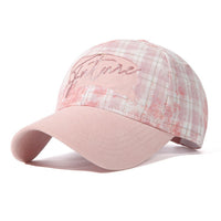 Pink cap with floral pattern and 'Bella' text on a white background