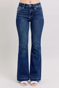 Blue flared jeans on a plain background
