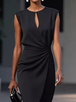Black dress with a keyhole detail worn by a model against a neutral background
