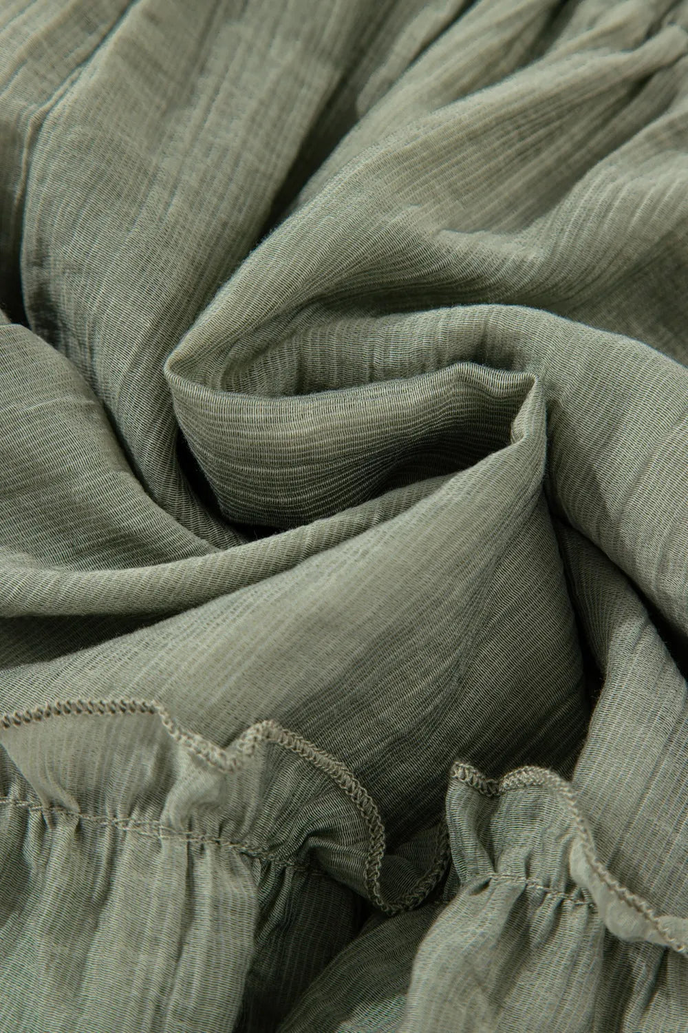 Close-up of green fabric with ruffled edges