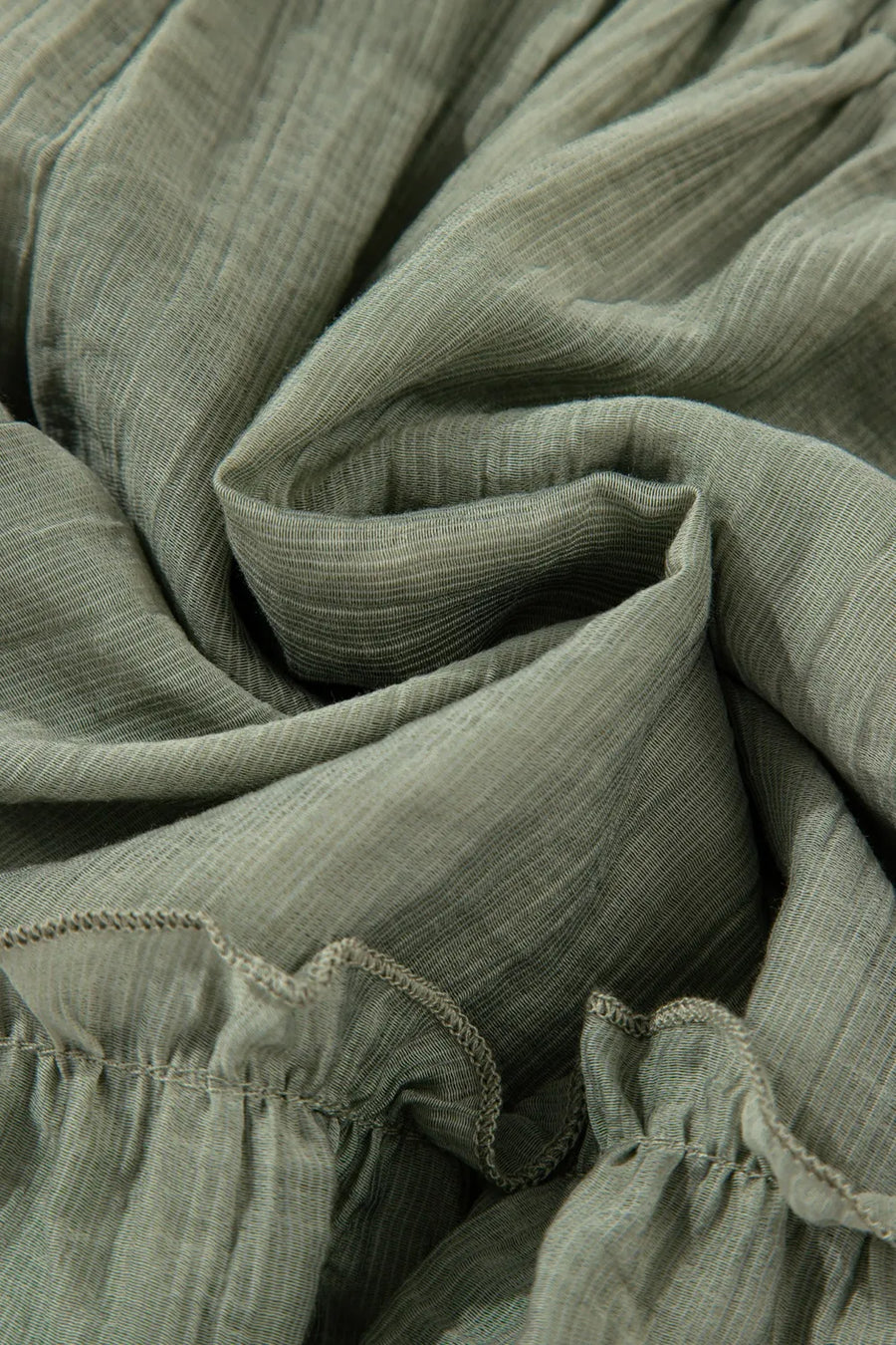 Close-up of green fabric with ruffled edges