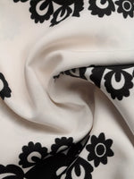 Close-up of white fabric with black floral patterns
