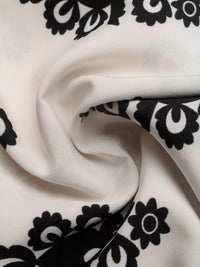 Close-up of white fabric with black floral patterns