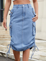 Blue denim skirt with ruched sides worn by a person on a neutral background