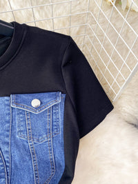 Black t-shirt with blue denim pocket design on a white background
