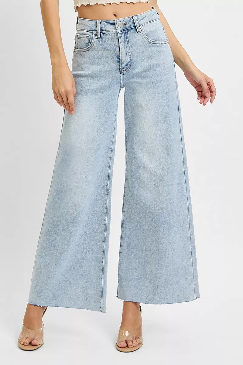 Light blue wide-leg jeans worn by a person on a white background