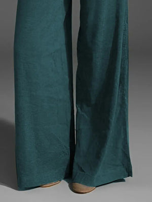Teal pants on a gray background