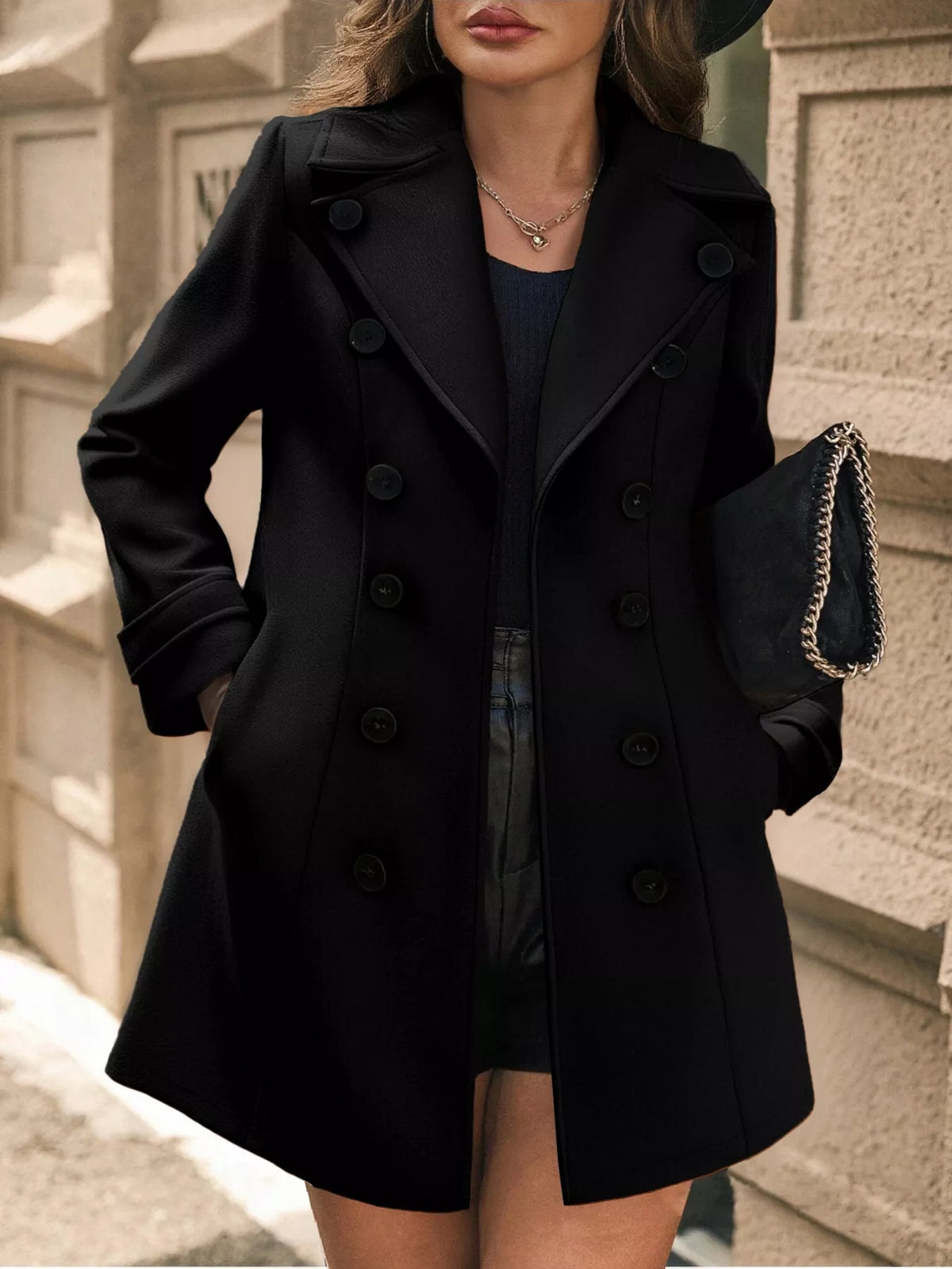 Woman wearing a black coat with a blurred background