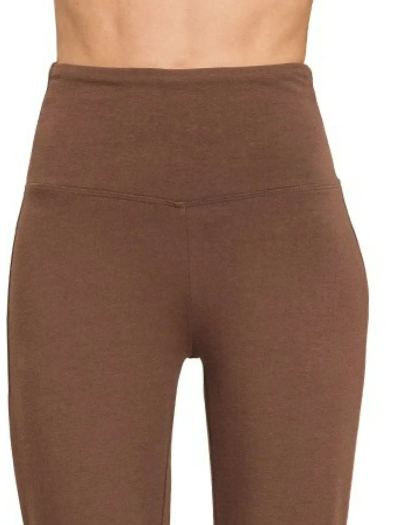 Brown leggings worn by a person on a white background