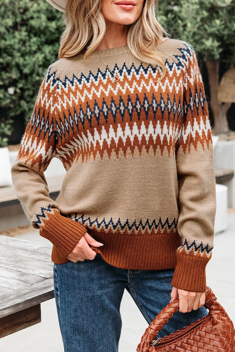 Person wearing a patterned sweater with brown and blue colors, standing outdoors.