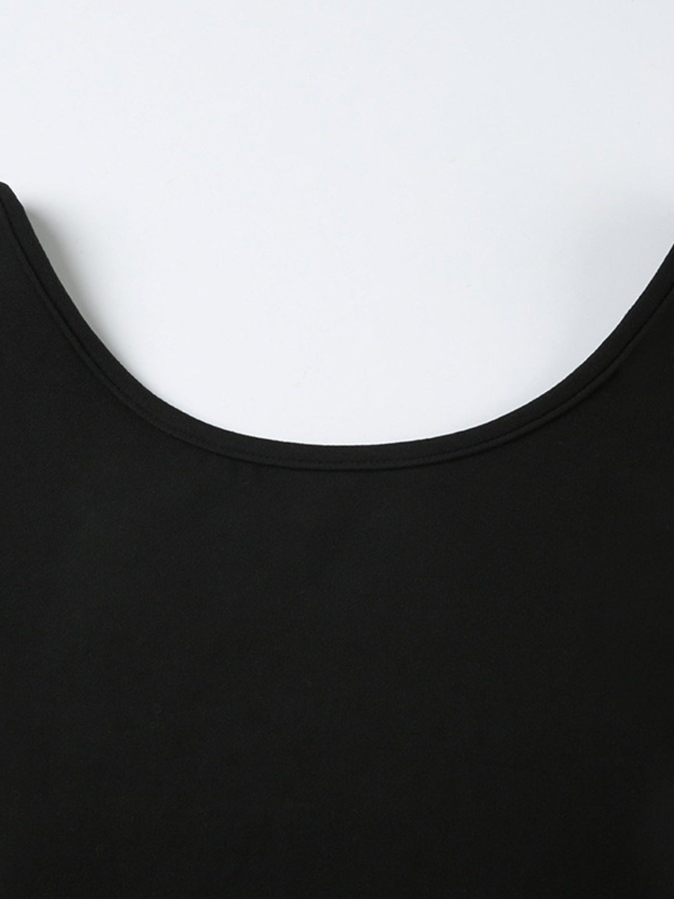 Close-up of a black garment with a white background