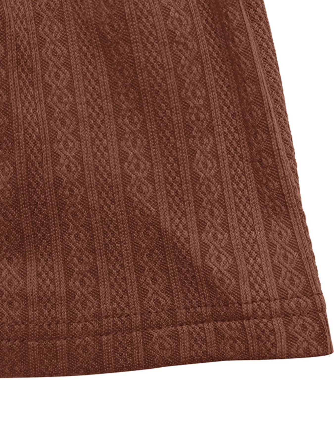 Close-up of a brown textured fabric with a geometric pattern on a white background