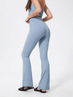 Light blue flared pants worn by a person on a white background