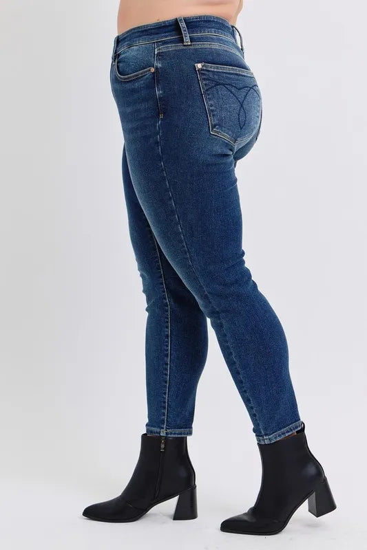 Blue jeans worn by a person on a white background