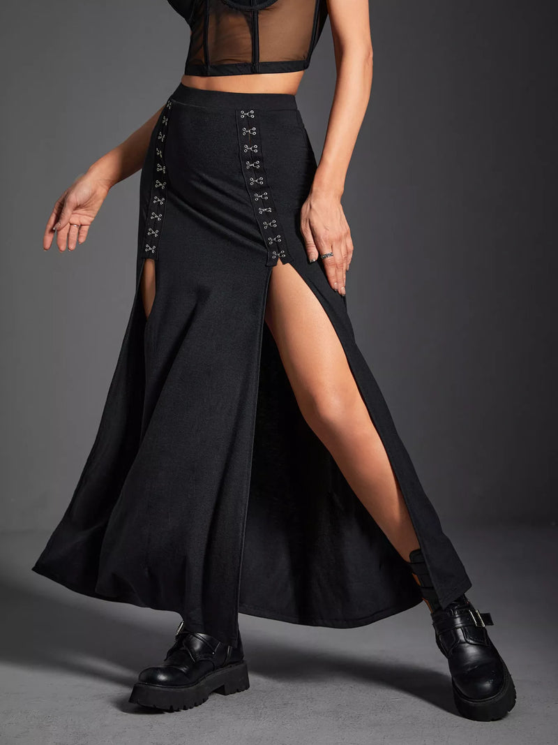 Person wearing a black lace-up skirt with a high slit on a gray background